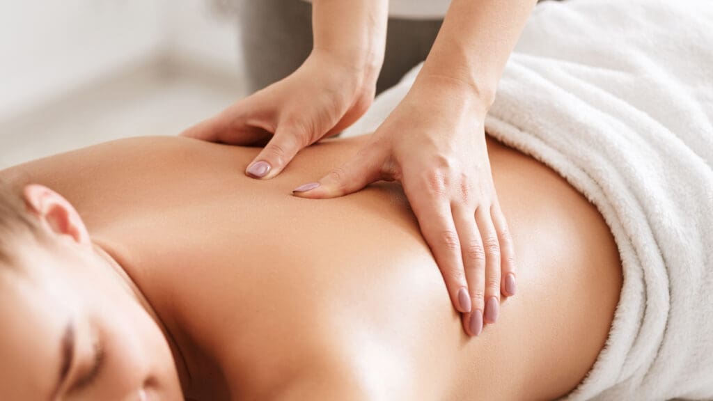 Women relaxing while receiving a massage, closeup.