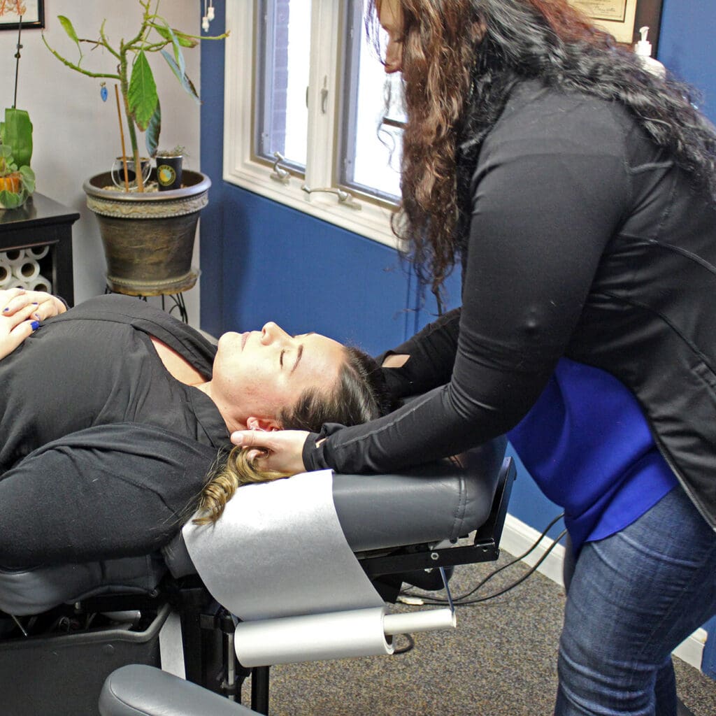 Patient receives a chiropractic adjustment from licensed chiropractor Dr. Wendy Iszler